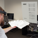 A user fanning out several holographic documents in their hands and enlarging one of them.