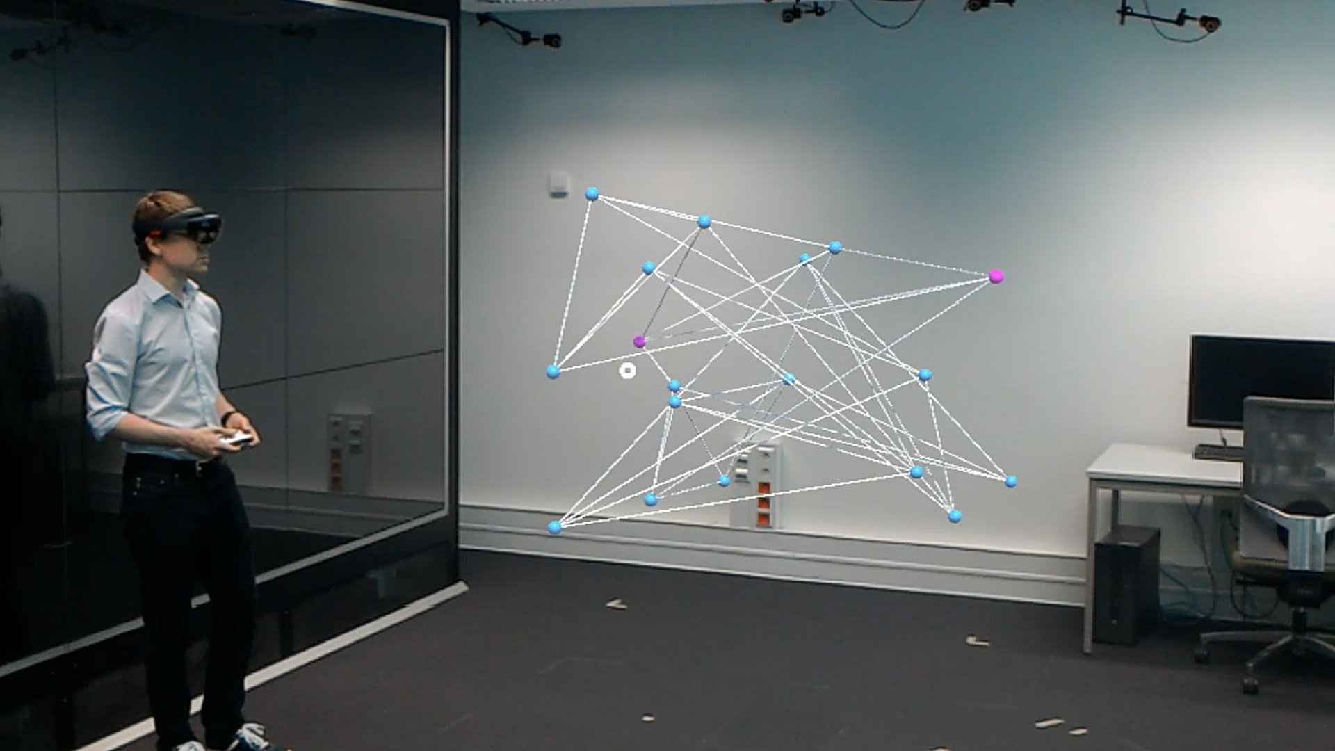 Thumbnail for the accompanying video of our article 'Augmented Reality Graph Visualization', showing a researcher using a HoloLens to explore an AR network visualization.