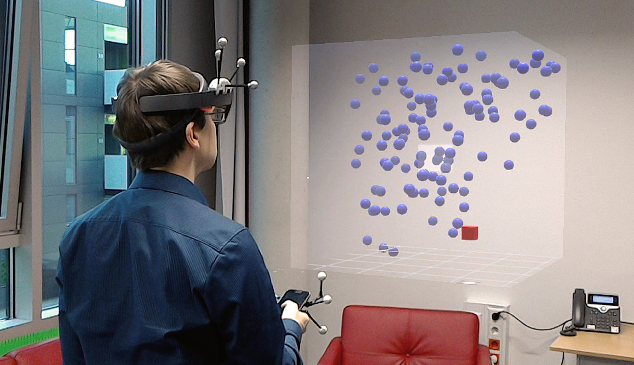 Thumbnail for the accompanying video of our paper 'Investigating Smartphone-based Pan and Zoom in 3D Data Spaces in Augmented Reality', showing a user wearing a HoloLens and using a smartphone to explore an AR data set.
